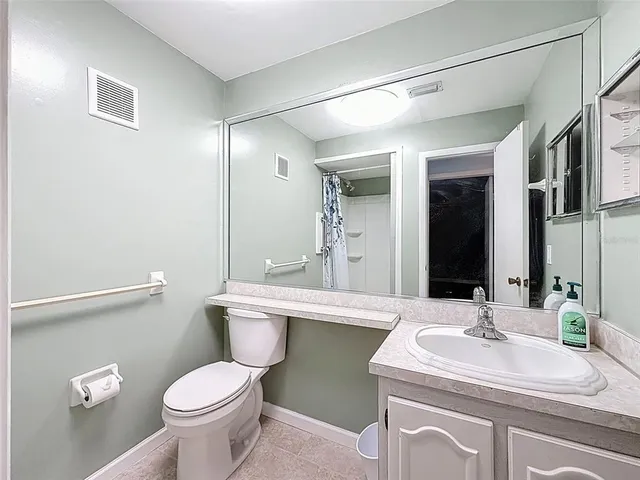 a bathroom with a sink toilet and a mirror