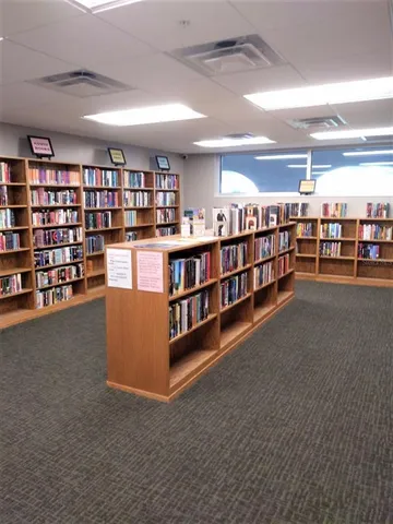 a living room with lots of furniture and a book shelf
