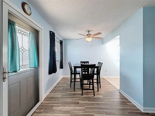 a view of a dining room with furniture and window