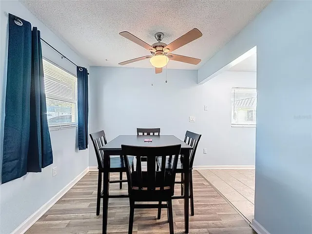 a view of a dining room with furniture and a chandelier
