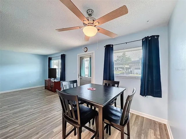 a view of a dining room with furniture window and wooden floor