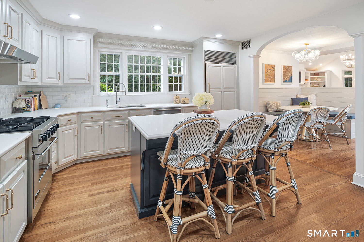 775 Sasco Hill Road Fairfield, CT 06824 - Photo 10 of 36 a kitchen with a table chairs sink and cabinets