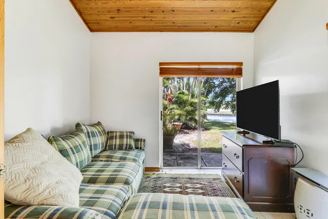 a bedroom with a bed and flat screen tv
