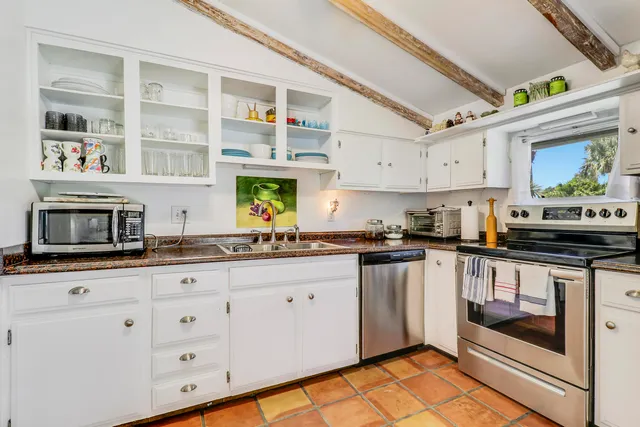 a kitchen with stainless steel appliances granite countertop a stove and cabinets
