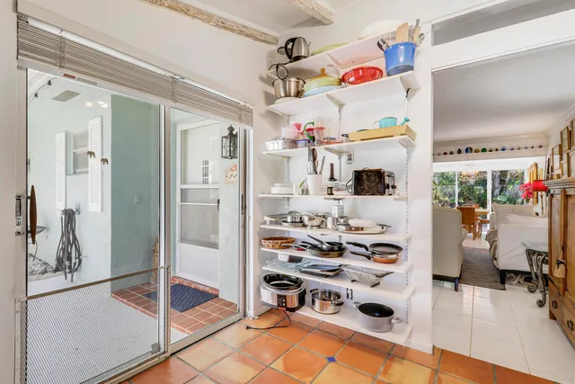 a room with stainless steel appliances kitchen island granite countertop a refrigerator and a counter top space