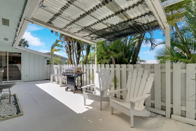 a view of a patio with a table and chairs with wooden floor