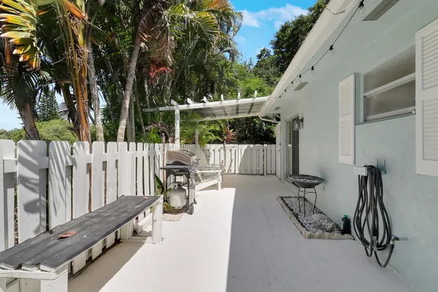 a building outdoor space with patio furniture and potted plants