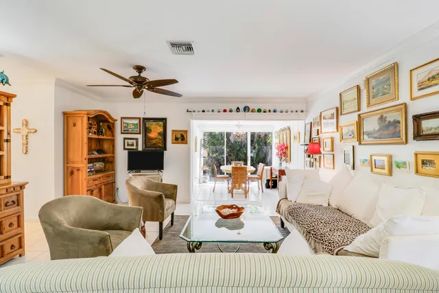 a living room with furniture ceiling fan and a rug