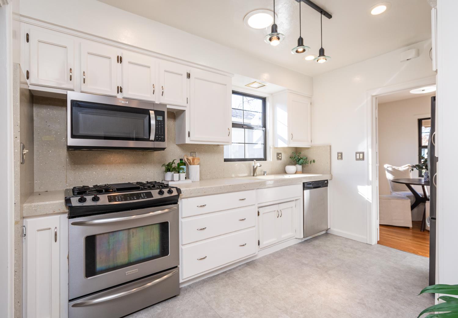 151 Coloma Way Sacramento, CA 95819 - Photo 11 of 28 a kitchen with granite countertop a stove a sink and a microwave