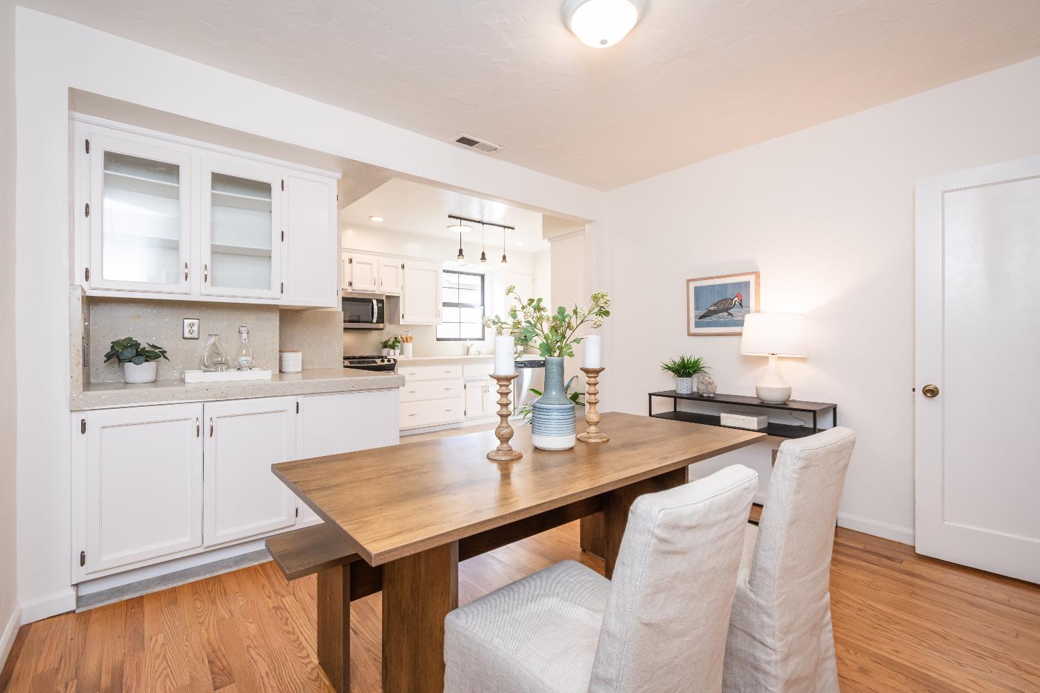 151 Coloma Way Sacramento, CA 95819 - Photo 12 of 28 a kitchen with stainless steel appliances a table chairs and a refrigerator