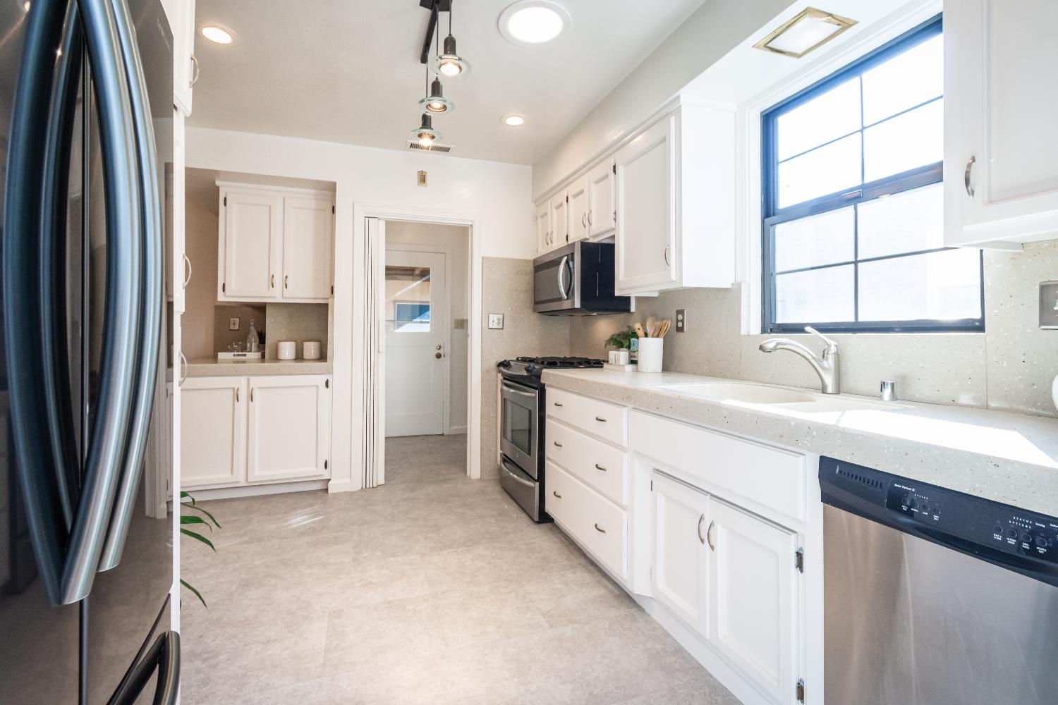 151 Coloma Way Sacramento, CA 95819 - Photo 9 of 28 a kitchen with stainless steel appliances a refrigerator sink and cabinets