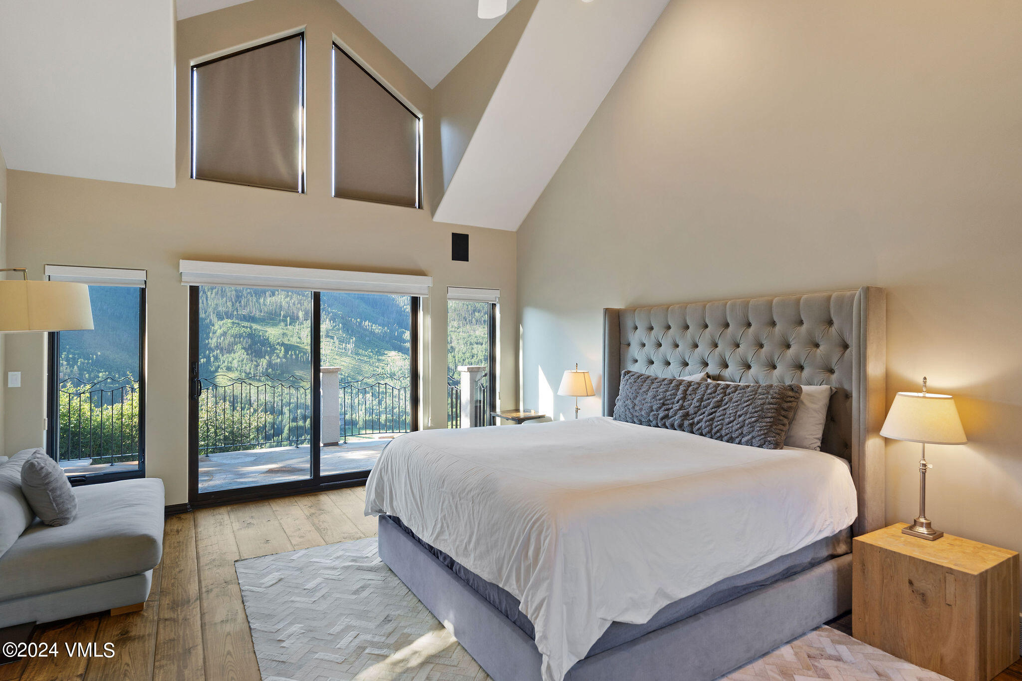 1675 Aspen Ridge Road Vail, CO 81657 - Photo 20 of 53 a bedroom with a large bed and a large window with outer view