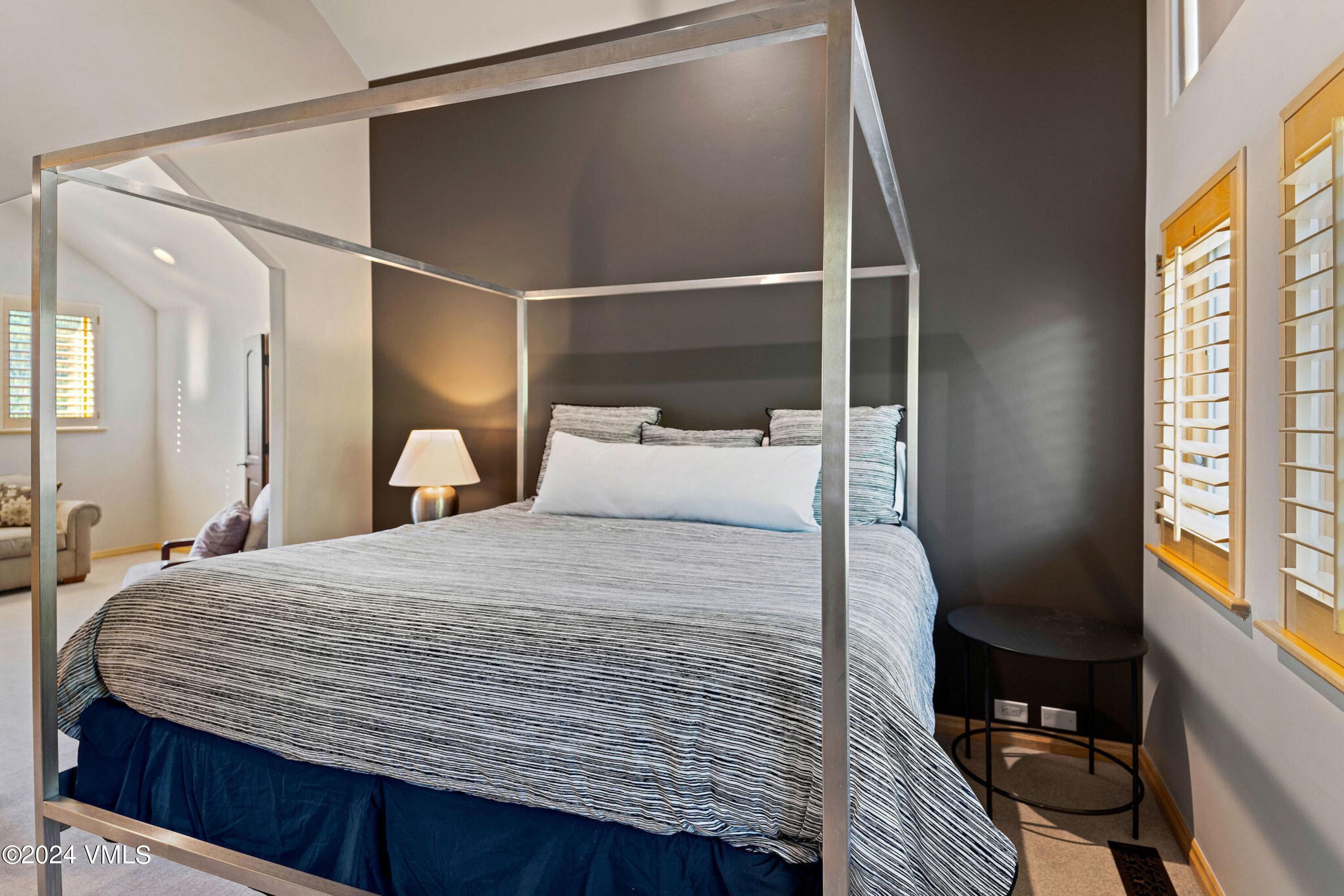 1675 Aspen Ridge Road Vail, CO 81657 - Photo 24 of 53 a bedroom with a bed and wooden floor