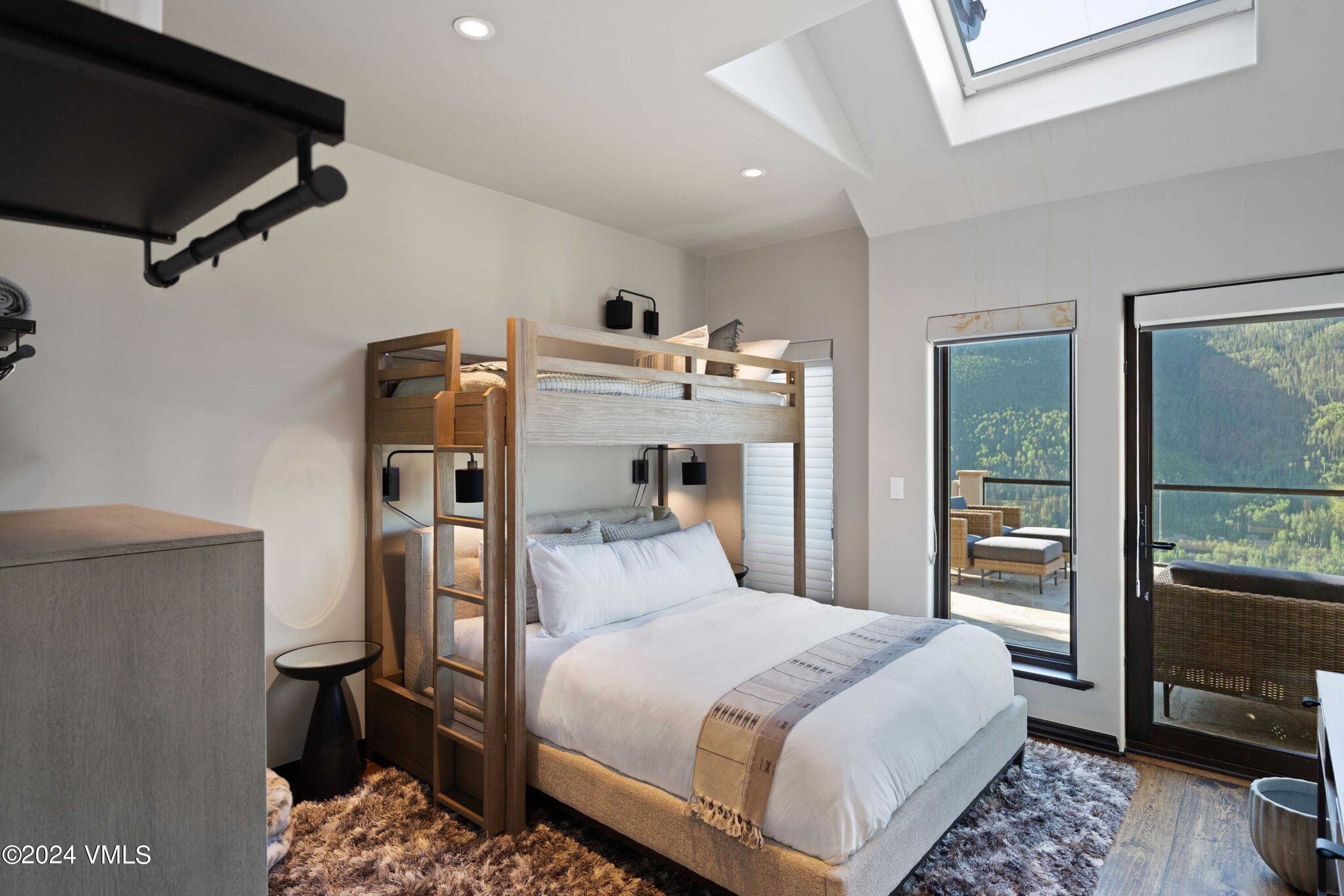 1675 Aspen Ridge Road Vail, CO 81657 - Photo 27 of 53 a bedroom with a bed and wooden floor