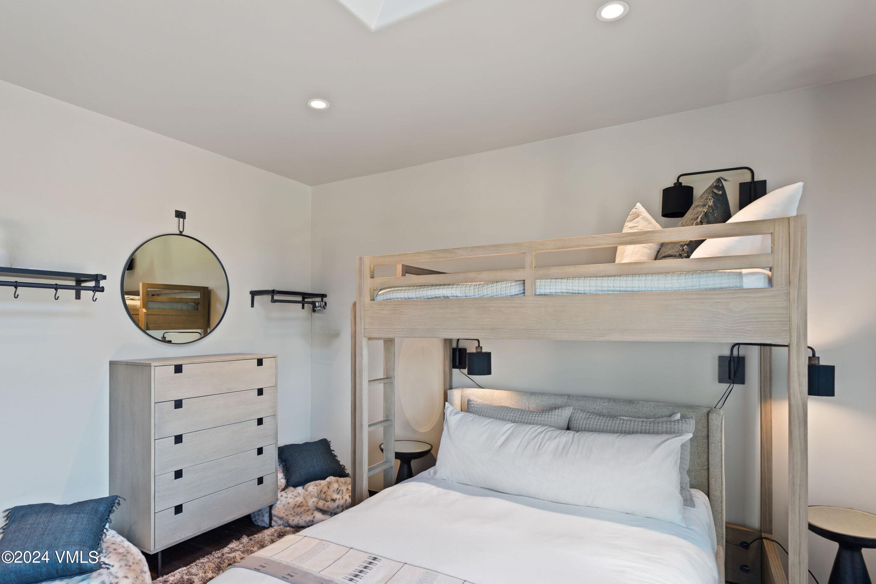 1675 Aspen Ridge Road Vail, CO 81657 - Photo 28 of 53 a bedroom with a bed and cabinets