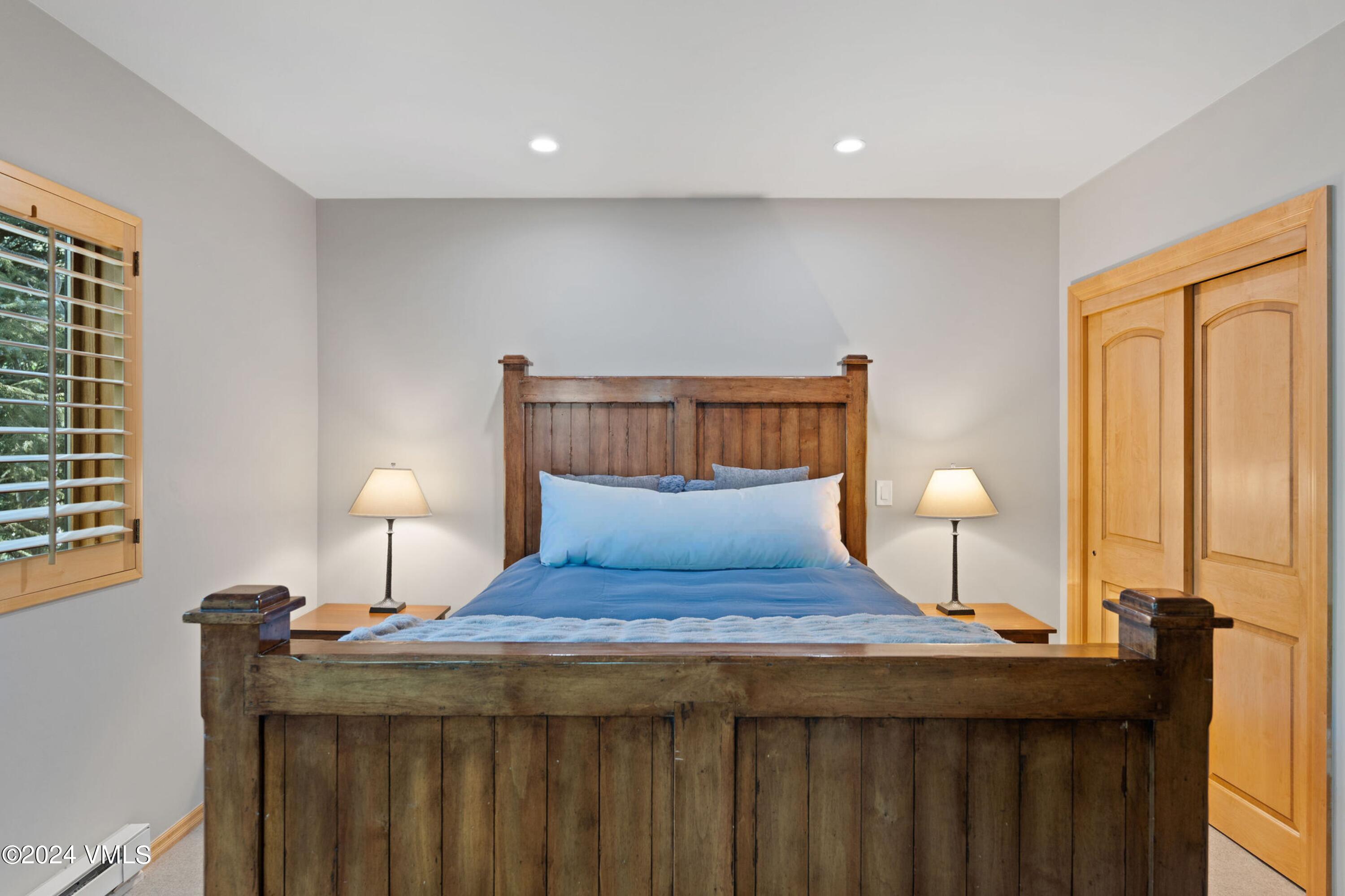 1675 Aspen Ridge Road Vail, CO 81657 - Photo 42 of 53 a bedroom with a bed and wooden floor