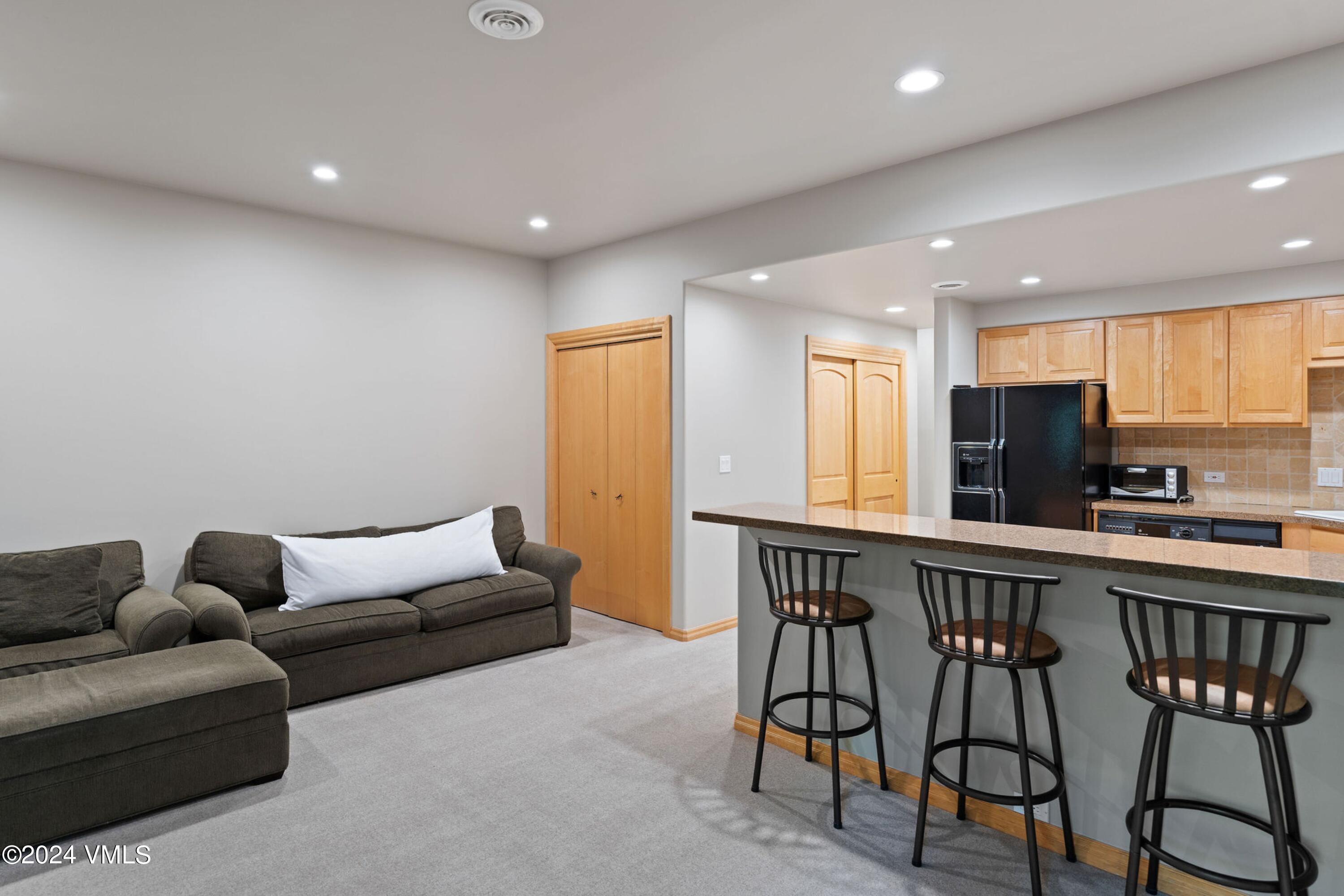 1675 Aspen Ridge Road Vail, CO 81657 - Photo 44 of 53 a living room with furniture a flat screen tv and a window