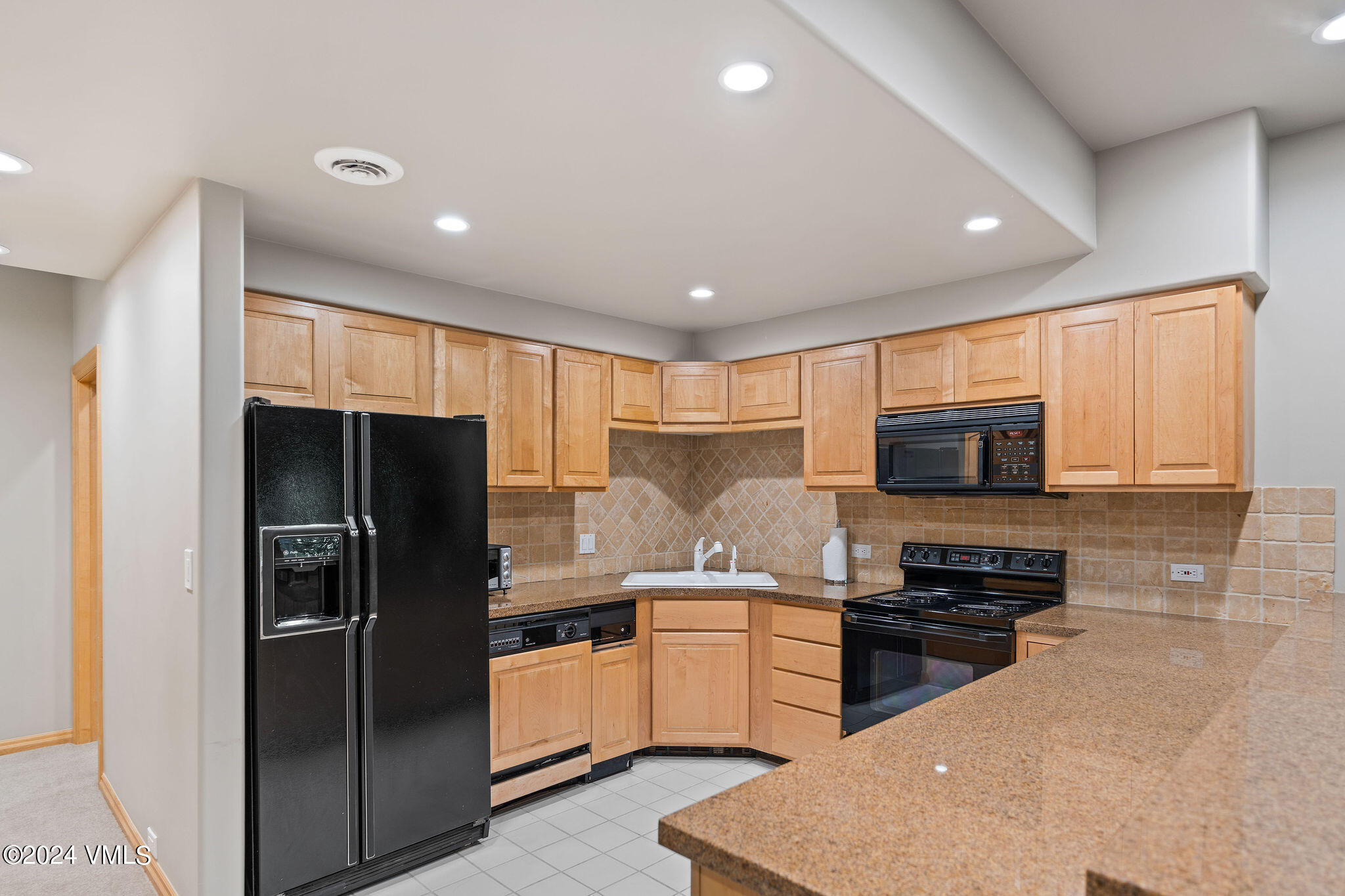 1675 Aspen Ridge Road Vail, CO 81657 - Photo 45 of 53 a kitchen with a refrigerator a stove top oven a sink and dishwasher