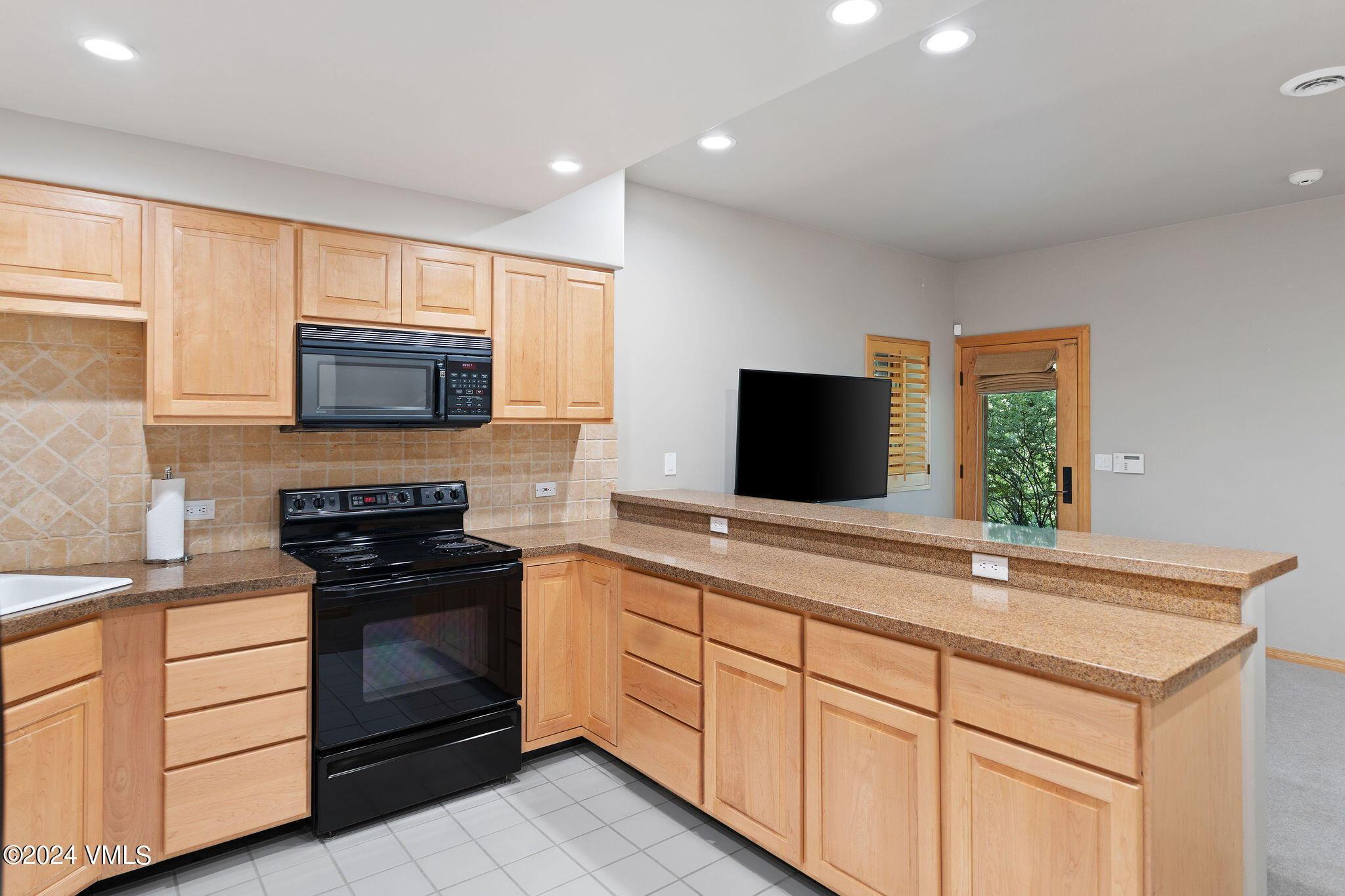 1675 Aspen Ridge Road Vail, CO 81657 - Photo 46 of 53 a kitchen with sink a microwave and stove