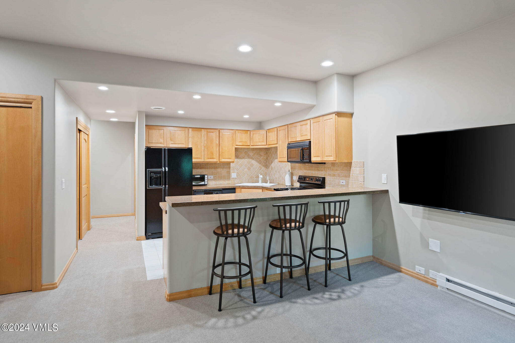 1675 Aspen Ridge Road Vail, CO 81657 - Photo 47 of 53 a kitchen with stainless steel appliances kitchen island granite countertop a refrigerator and a stove top oven