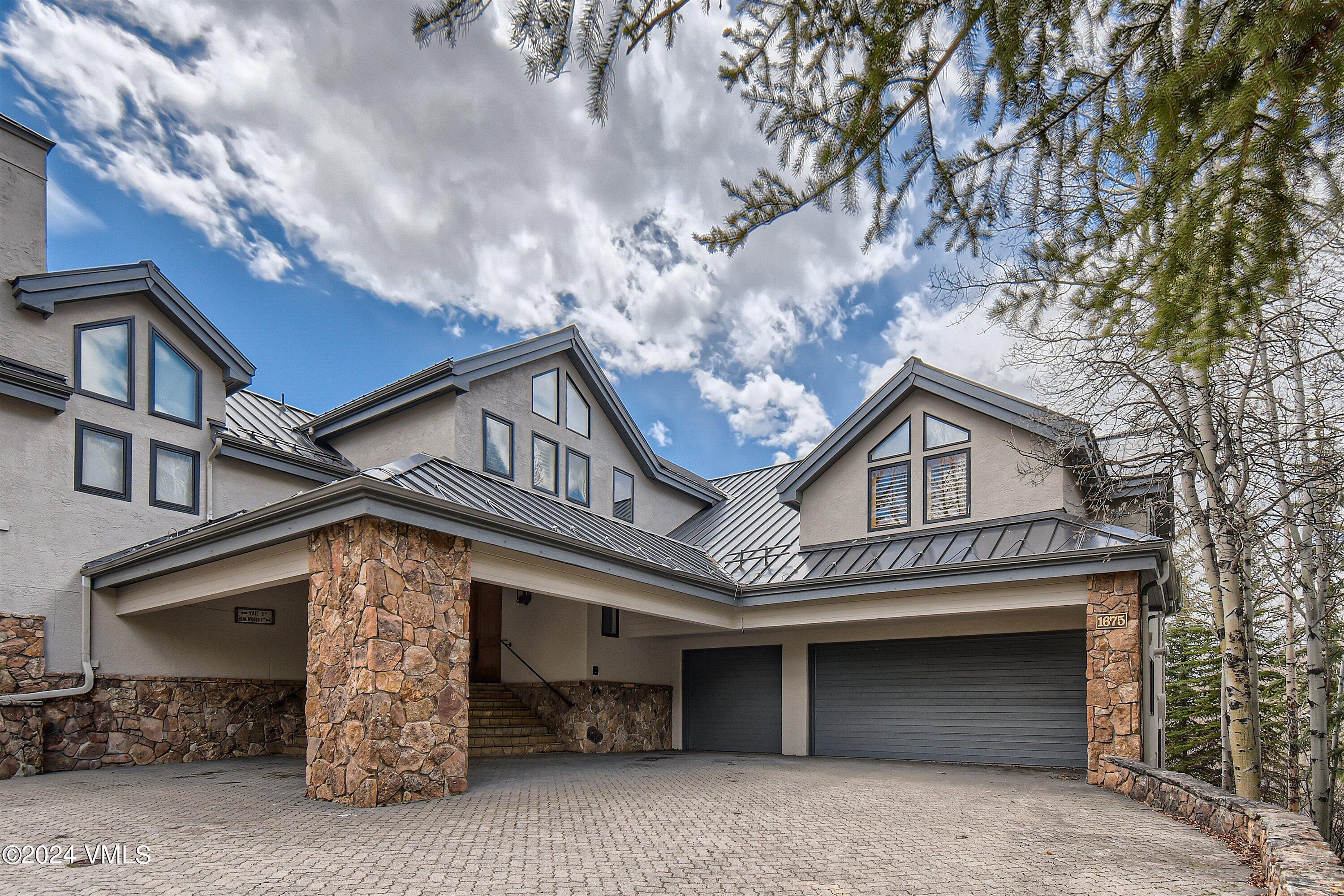 1675 Aspen Ridge Road Vail, CO 81657 - Photo 48 of 53 a front view of a house with parking space and garage