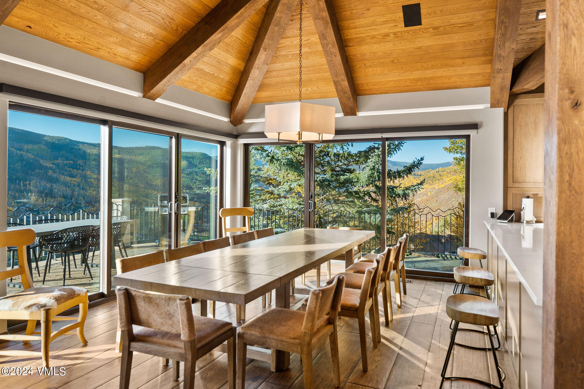 1675 Aspen Ridge Road Vail, CO 81657 - Photo 5 of 53 a dining room with furniture and a floor to ceiling window