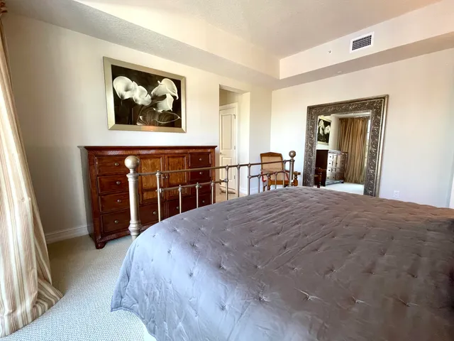 a bedroom with a bed and a dresser