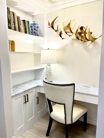 a view of a room with a table and chairs