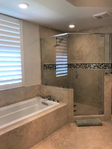 a bathroom with a bathtub and a shower