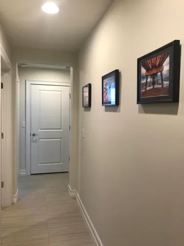 a spacious bedroom with a bed and a chandelier
