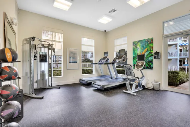 a view of a swimming pool with a lawn chairs under an umbrella