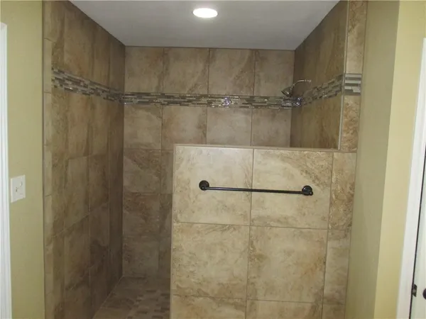 a bathroom with a glass shower door