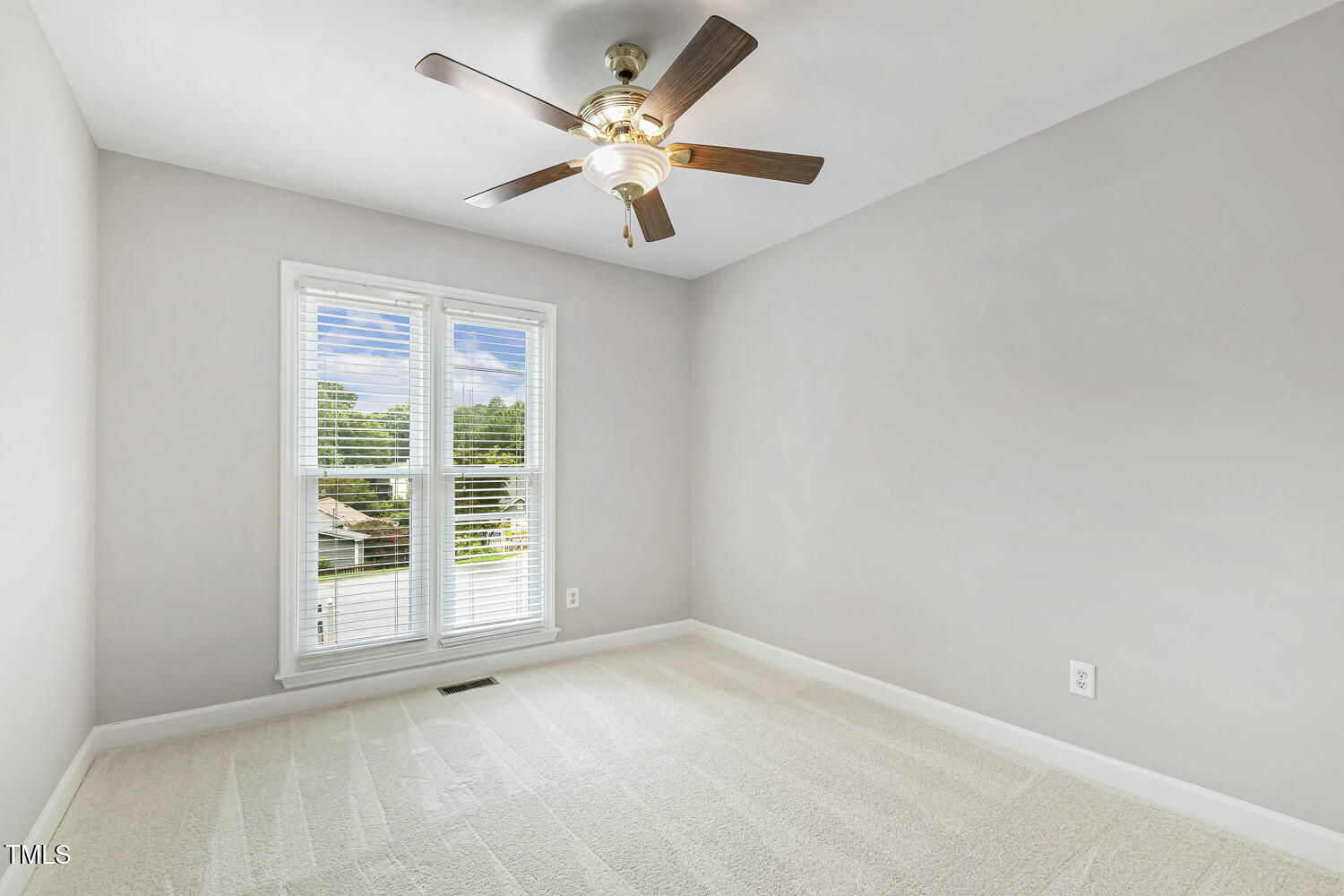 2105 Cardhu Way Raleigh, NC 27603 - Photo 8 of 9 an empty room with windows and fan