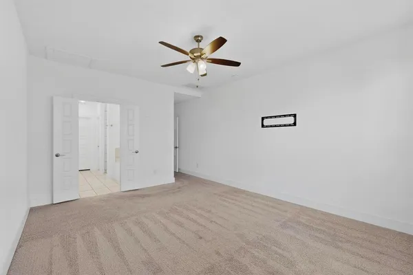 a view of a livingroom with a ceiling fan and window