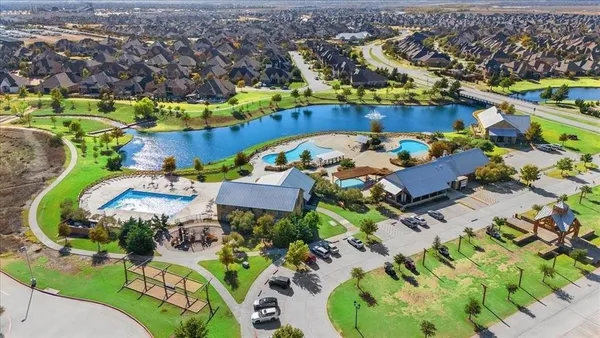 an aerial view of a house with a swimming pool yard and outdoor seating