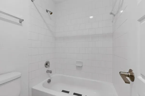 a bathroom with a shower and a bathtub