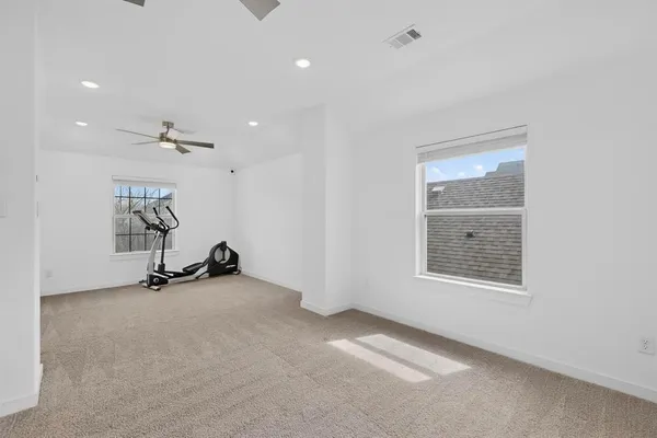 a view of a room with gym equipment and a large window