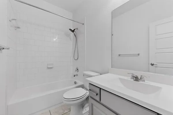 a bathroom with a sink toilet vanity and shower