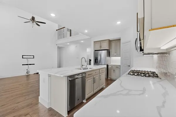 a kitchen with a stove a sink and a refrigerator