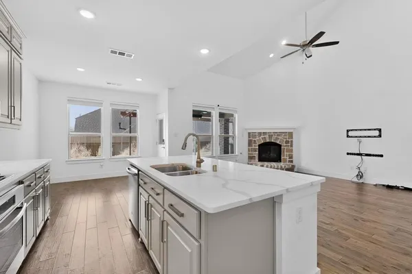 a open kitchen with sink cabinets and wooden floor