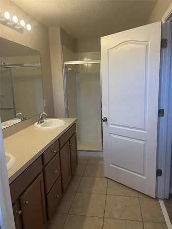 a bathroom with a double vanity sink and mirror