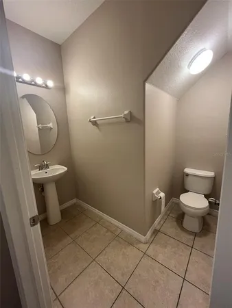 a bathroom with a toilet sink and vanity