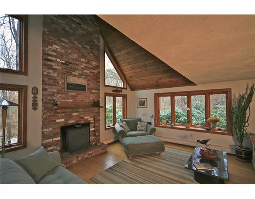 55 Linden Road Barrington, RI 02806 - Photo 4 of 12 Den/Family/Great Room. looking down from second floor stairway into great room with two story chimney, polished wood mantel ready for holiday decorations smart hardwood floors and alll new casement windows trimmed in warm natural woods.