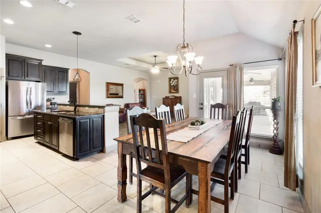 a kitchen with stainless steel appliances granite countertop a sink a stove and a wooden floors