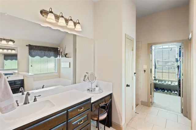 a bathroom with a sink a mirror and a shower