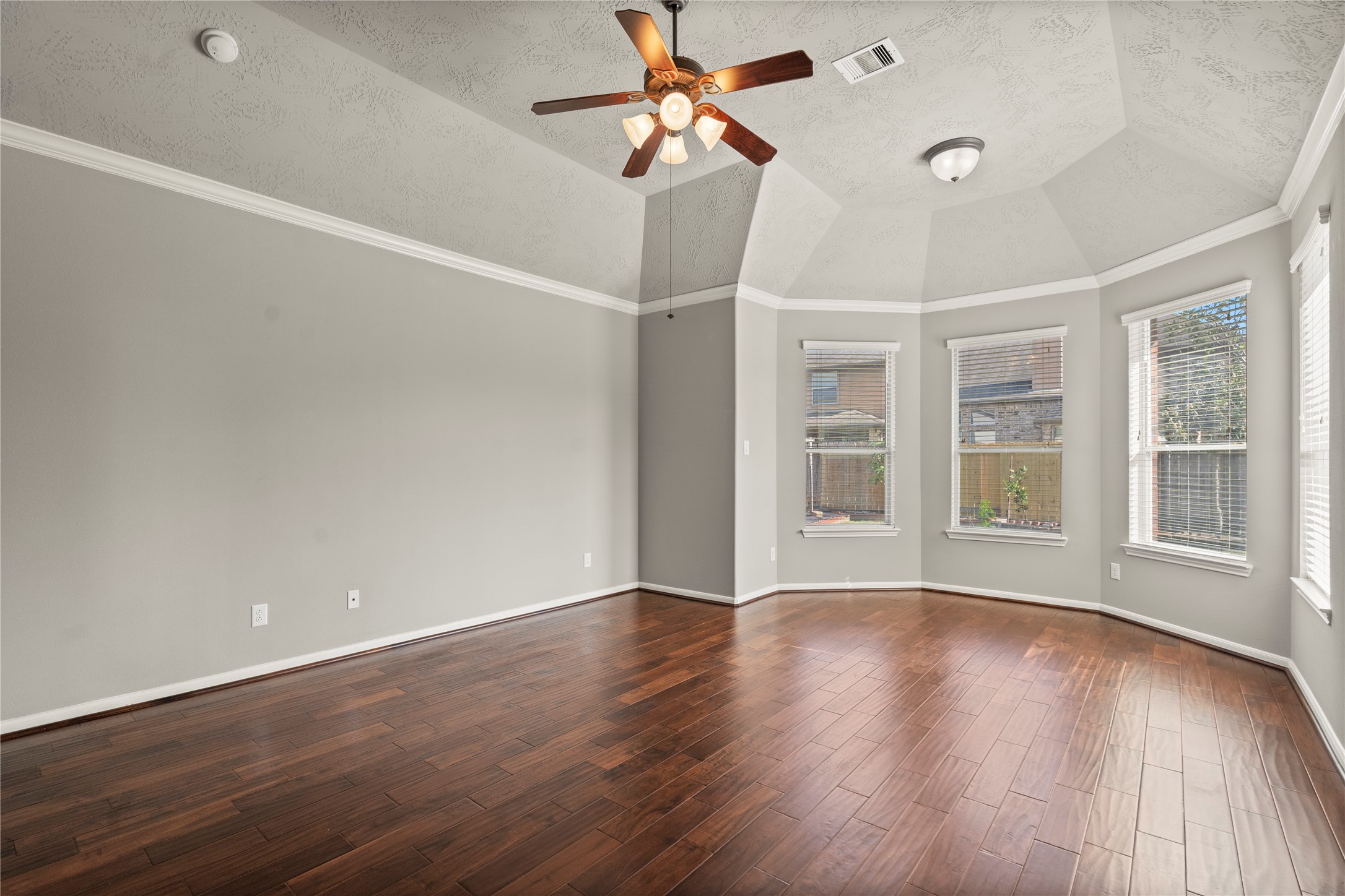 5307 Amber Sky Lane Rosharon, TX 77583 - Photo 14 of 44 a view of an empty room with wooden floor and a ceiling fan