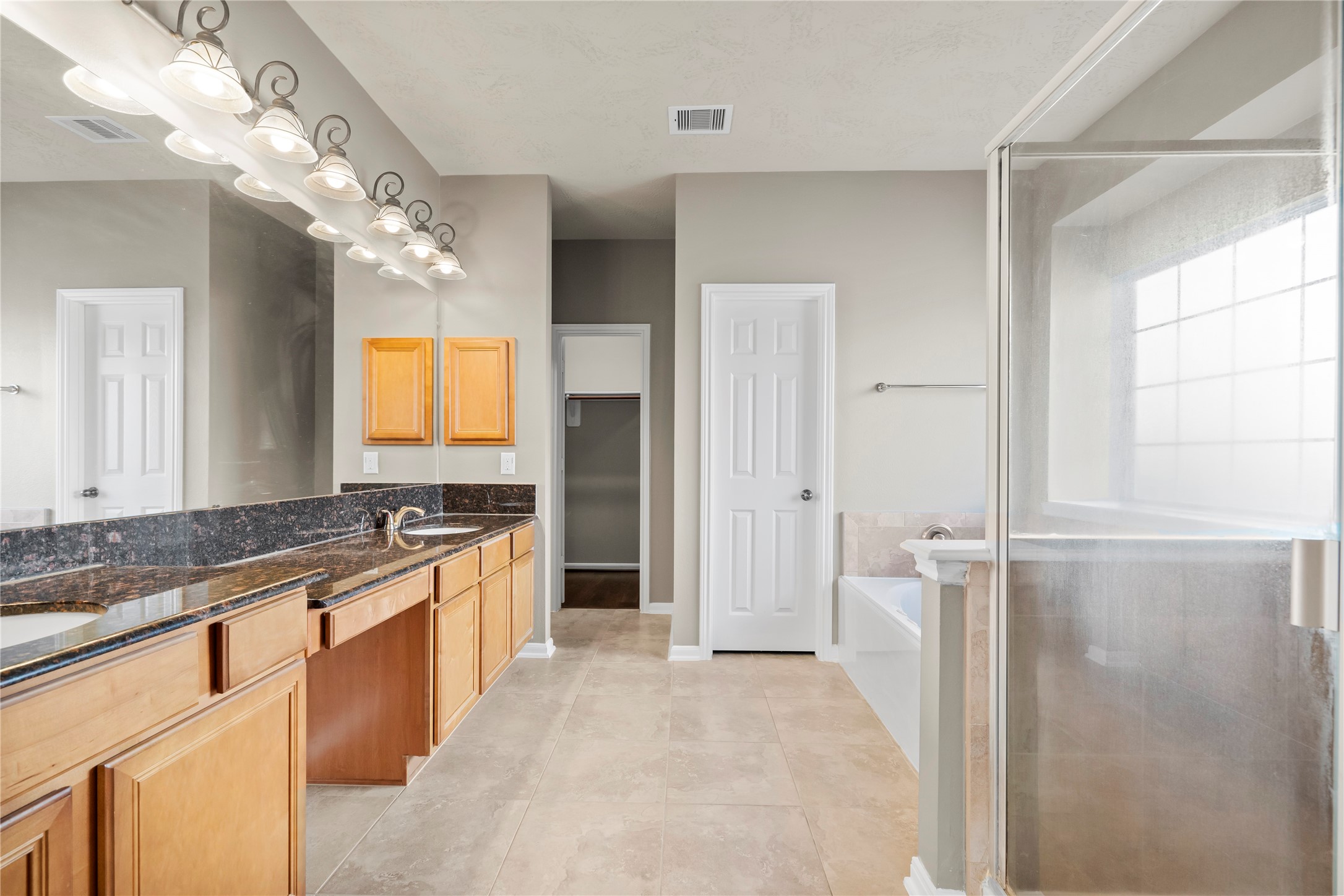 5307 Amber Sky Lane Rosharon, TX 77583 - Photo 15 of 44 a large bathroom with a granite countertop sink a large mirror and a shower