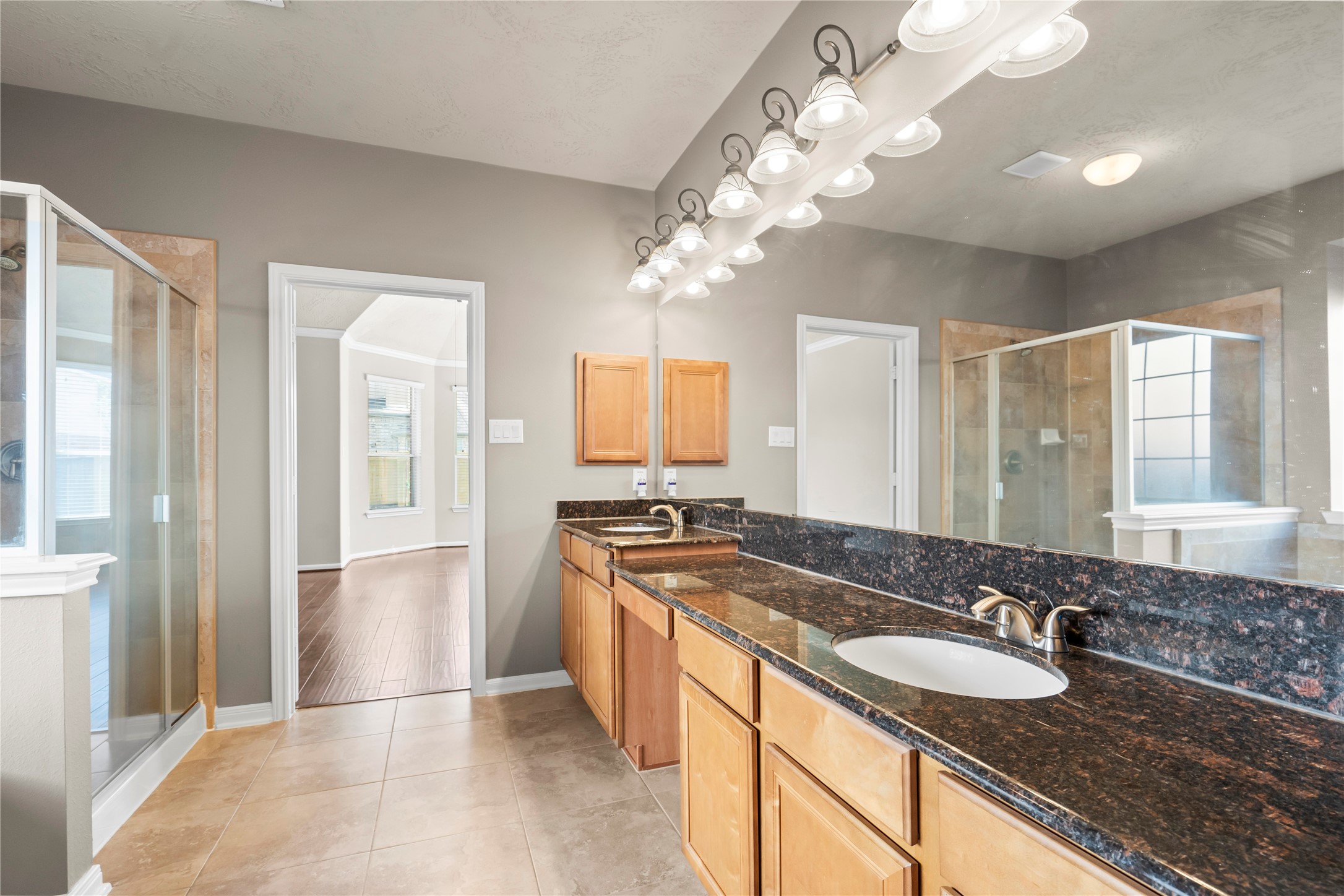 5307 Amber Sky Lane Rosharon, TX 77583 - Photo 17 of 44 a spacious bathroom with a granite countertop double vanity sink a mirror and a shower