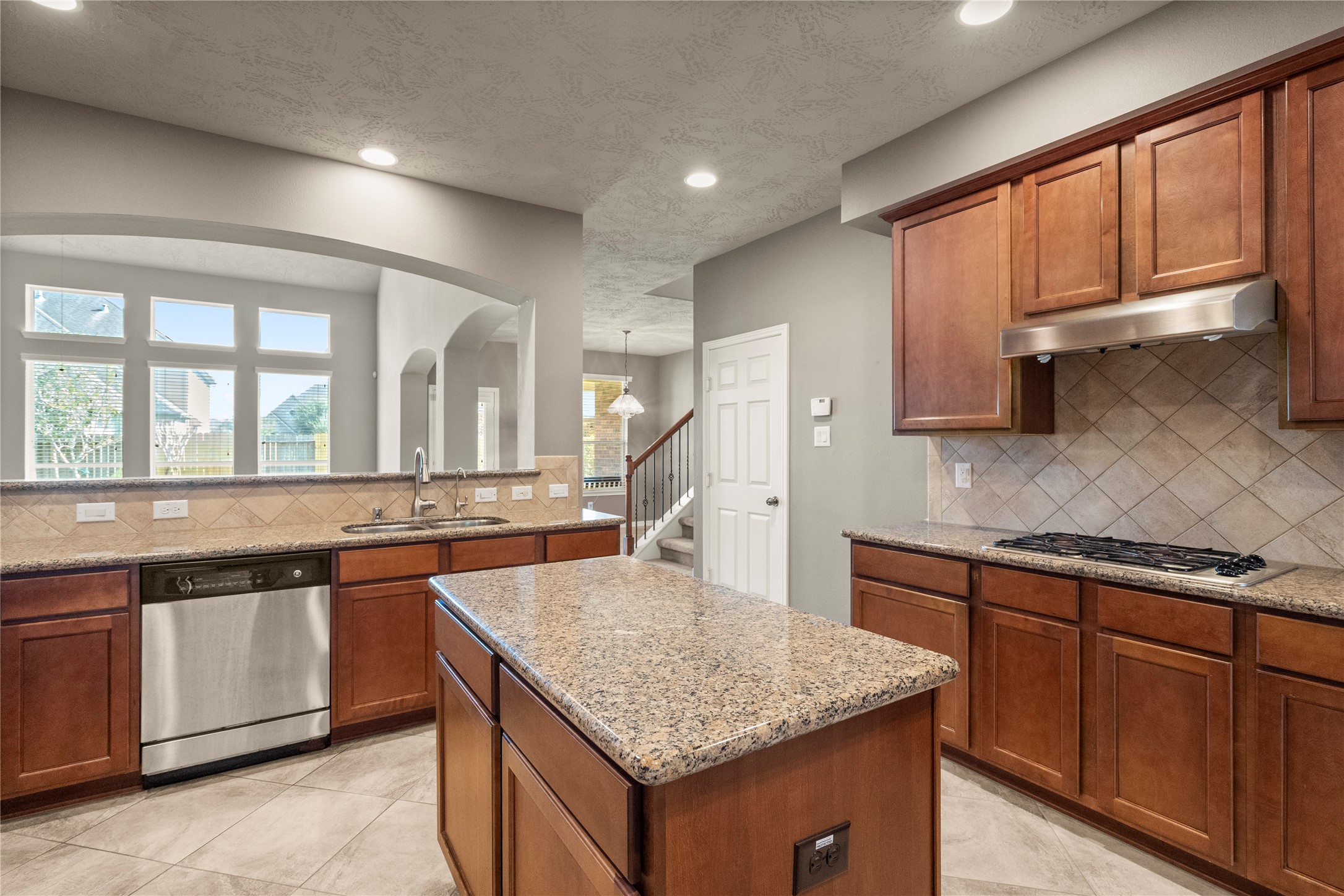 5307 Amber Sky Lane Rosharon, TX 77583 - Photo 23 of 44 a kitchen with a stove a sink a microwave and wooden cabinets