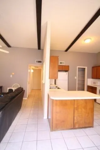a kitchen with a sink and a refrigerator